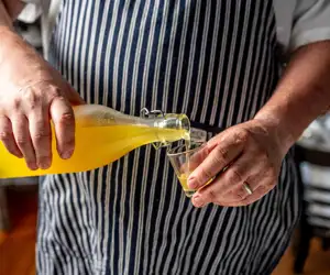Chef DeBellis pouring a glass of limoncello. 